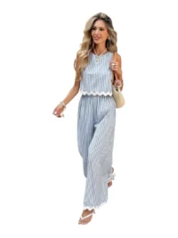 Model walking in blue striped wide-leg summer set with sleeveless scalloped top.